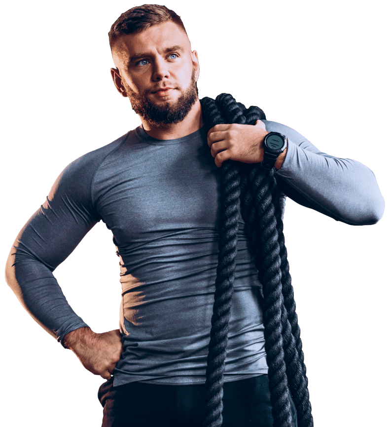 a well built fitness instructor wearing ropes on his shoulder