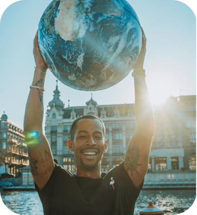 Man holds a large globe of the planet Earth above his head. The strength and interaction of the sides are reversible.