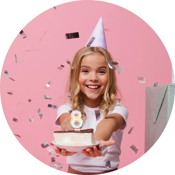 a little girl holding a cake