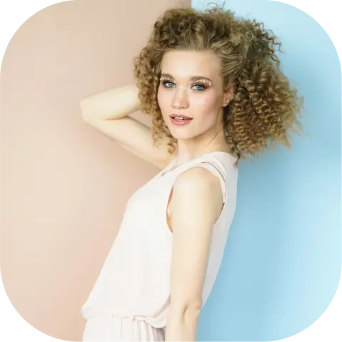 a girl in a white t-shirt with curly hair