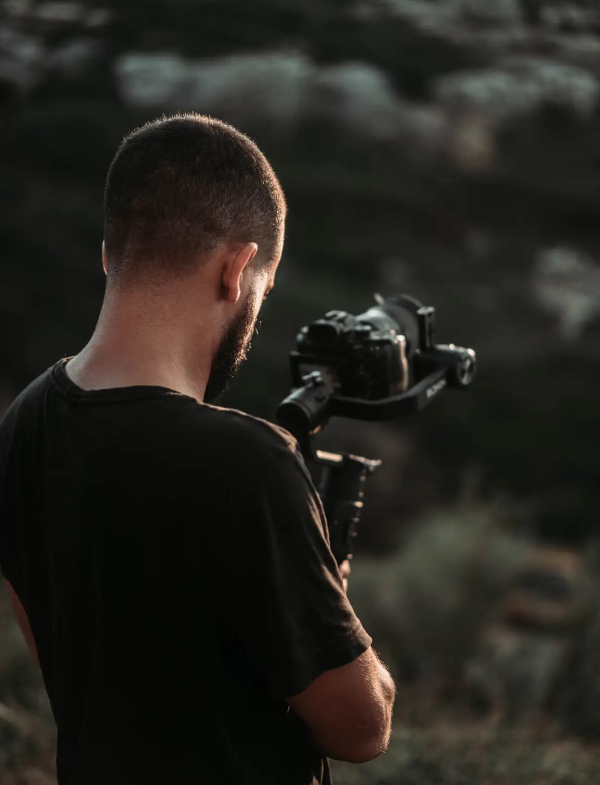 homem usando estabilizador de movimento para tirar fotos da natureza com sua câmera
