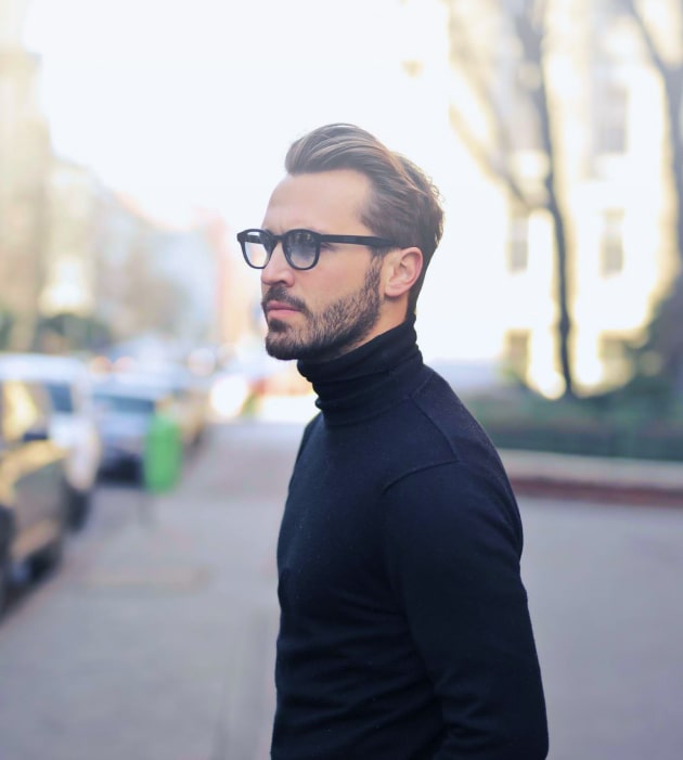 young caucasian male with designer frames and in turtleneck