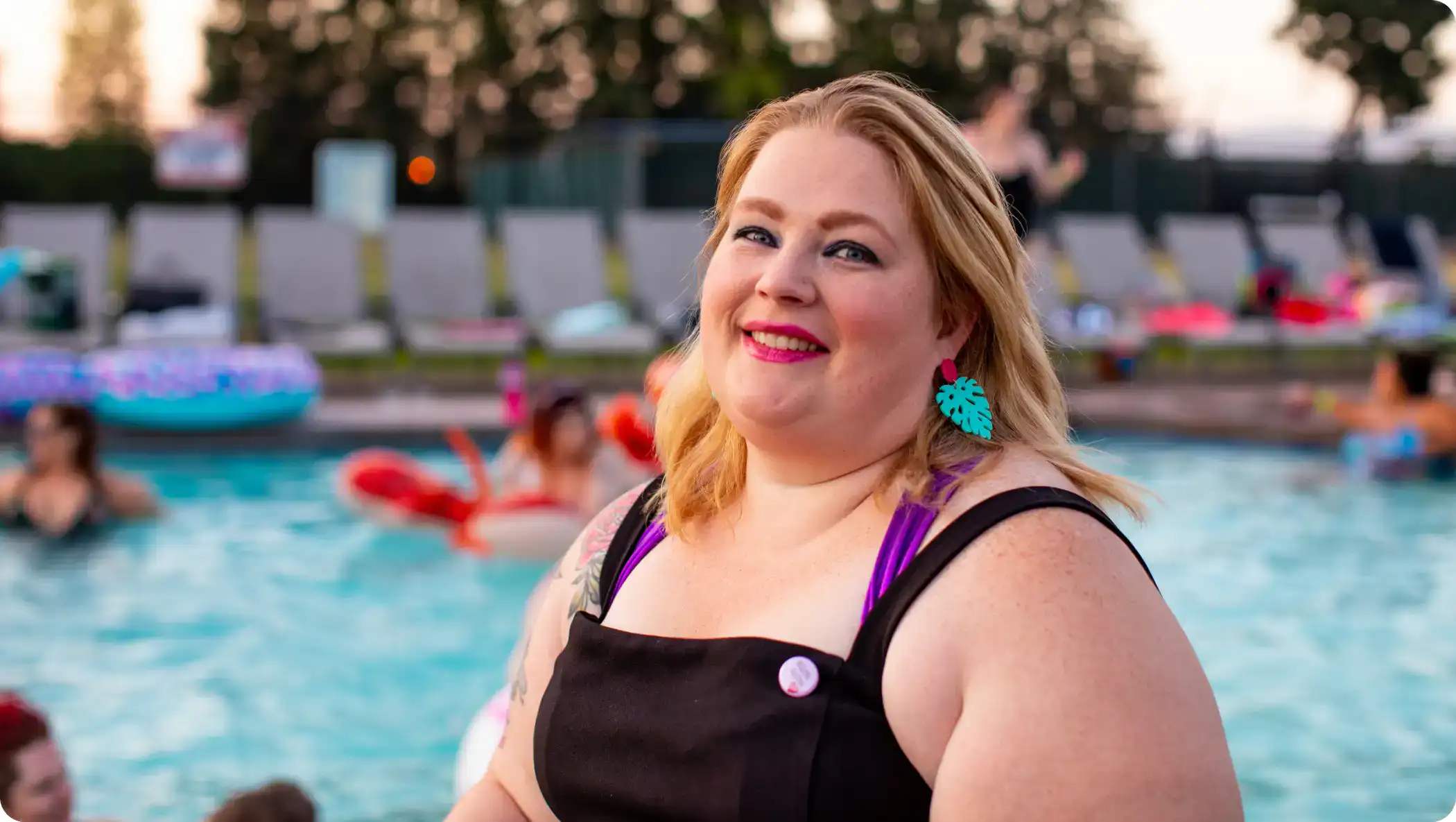 an overweight woman in a pool smiling at the camera