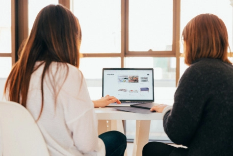 two women looking up new website designs