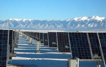 many solar panels near the mountains