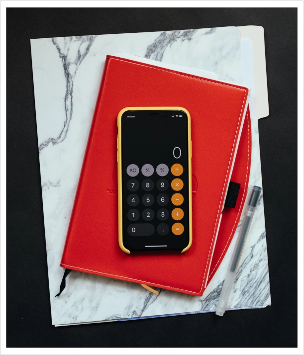 a photo of a phone on top of a notebook