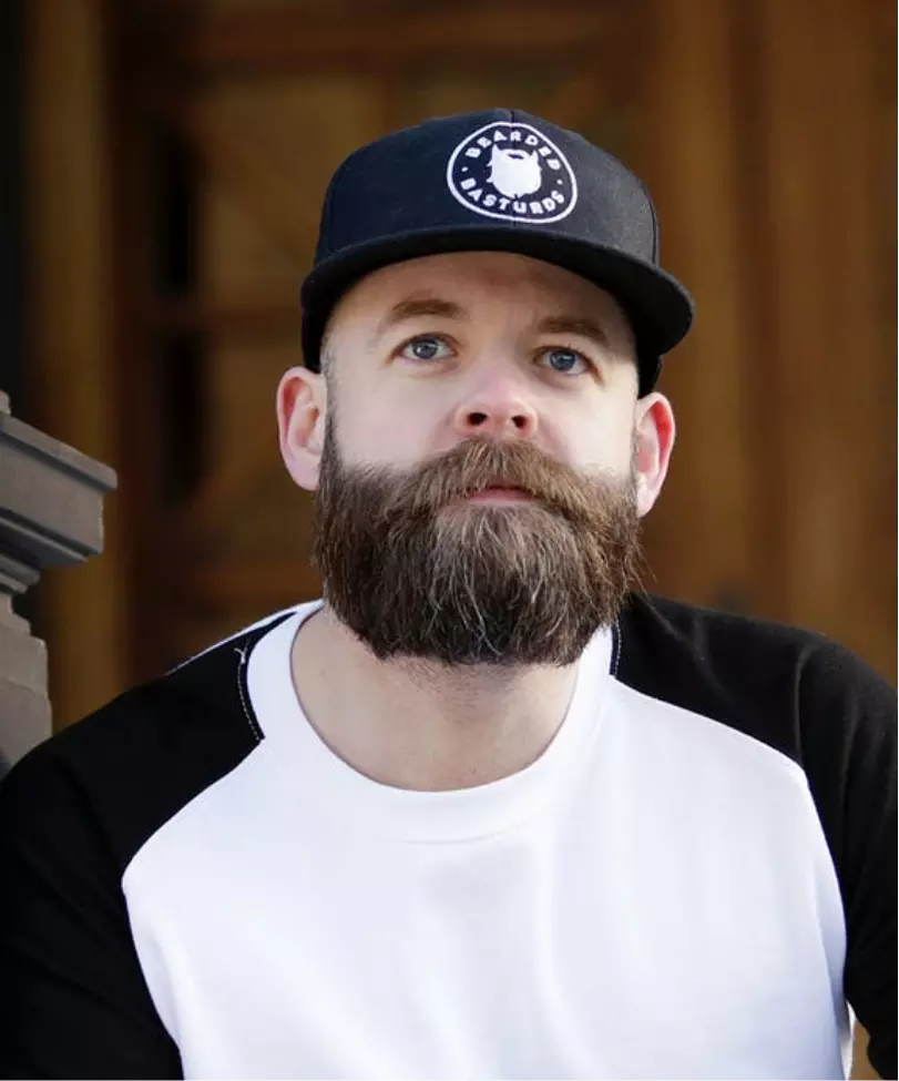 a man with a beard and a cap