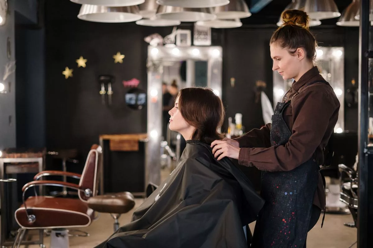 a girl gets her hair done in a beauty salon