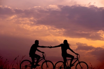 a photo of two people riding bikes