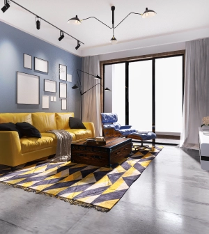 a photo of a living room with yellow sofas and carpet