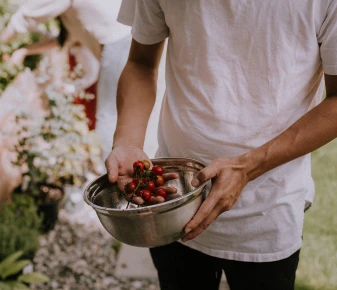 a photo of a farmer with a bowl in his hands