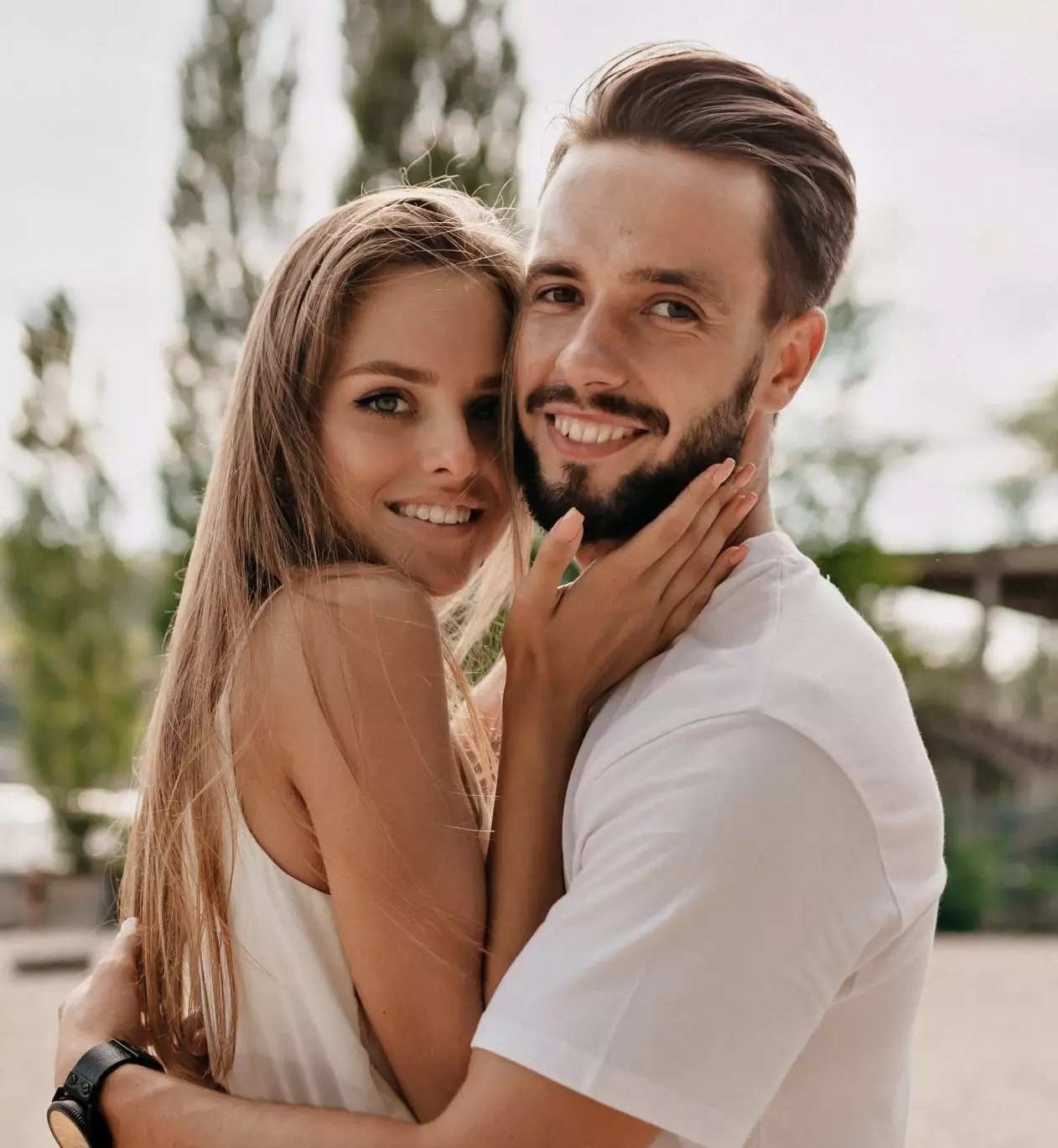 Couple people smiling while hugging