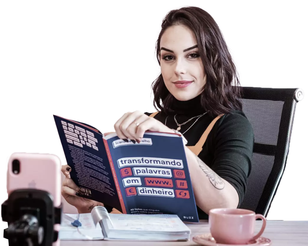 a girl is sitting on a chair and holding a book