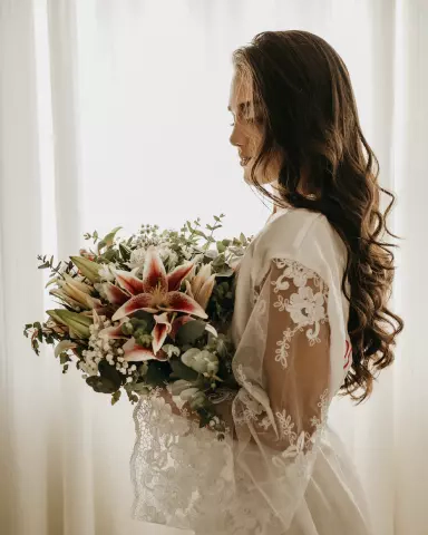 Bride in a white dress with a beautiful bouquet of flowers