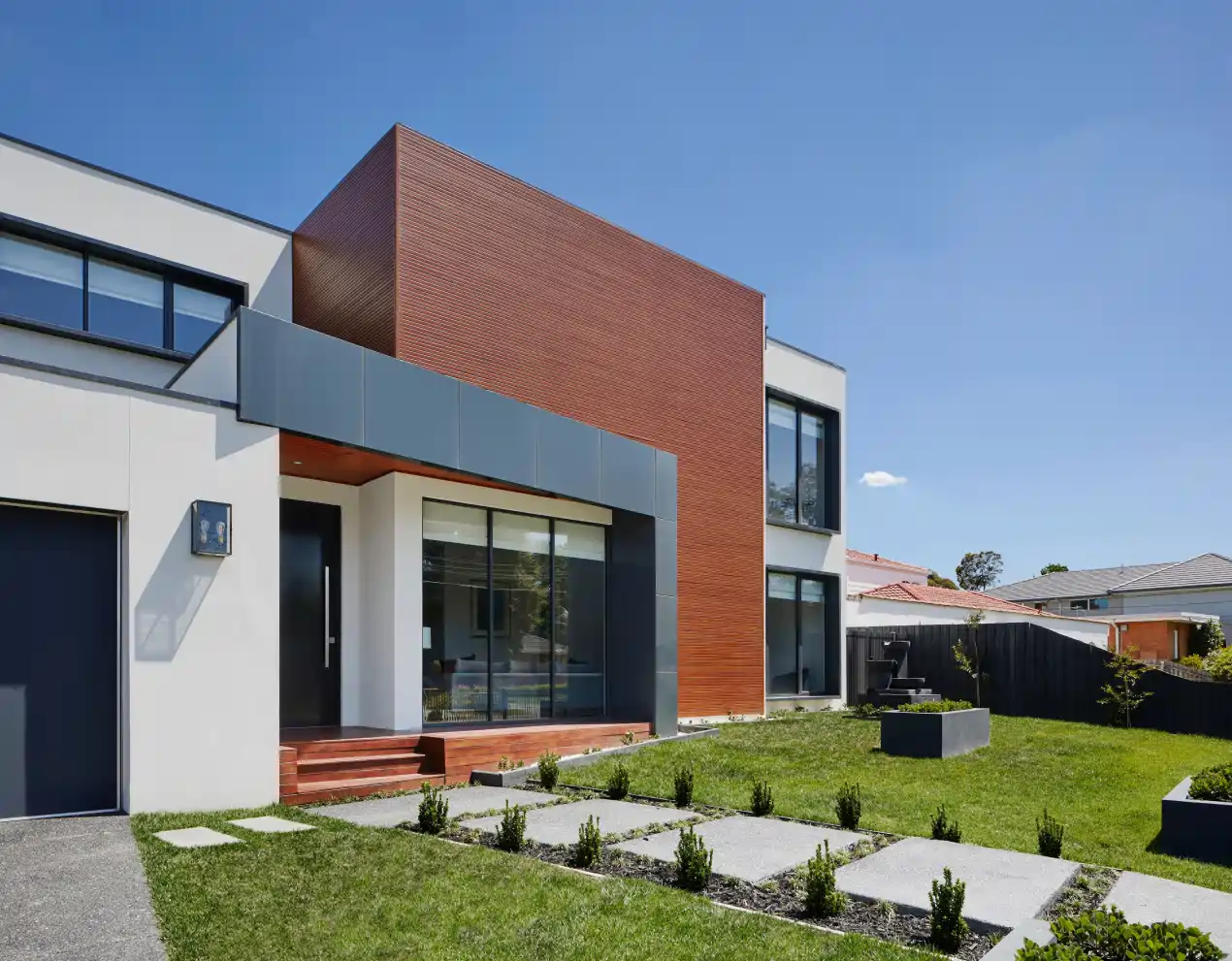 a modern house made with bricks, concrete and steal plates