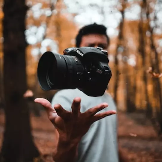 a man holds a camera