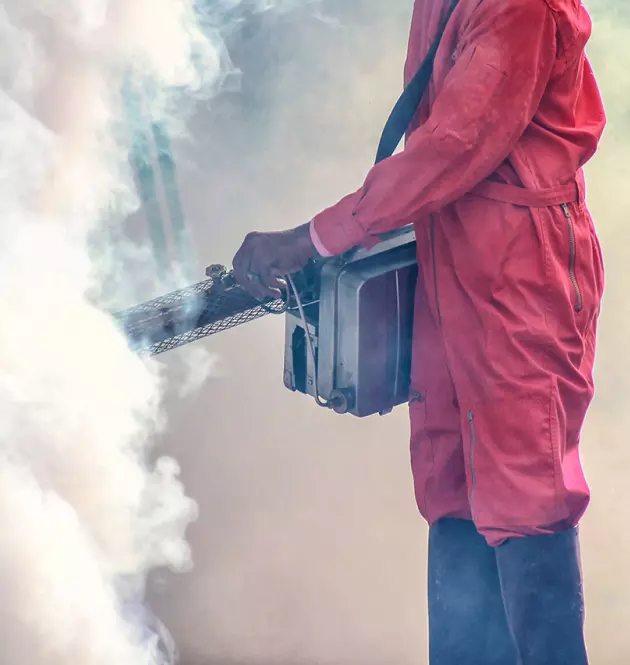 an employee in a protective red suit