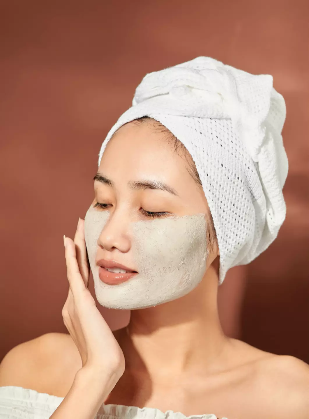 a girl with a white towel on her head