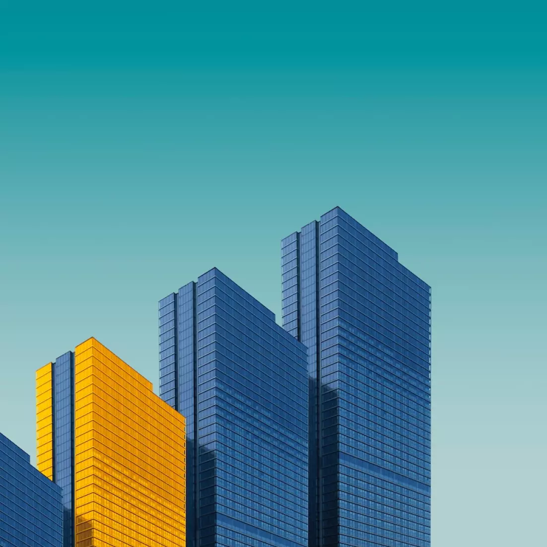 Three high-rise buildings, one yellow and two blue