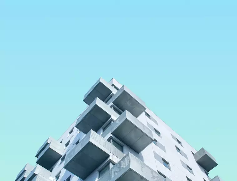 Gray building with many balconies on the corner