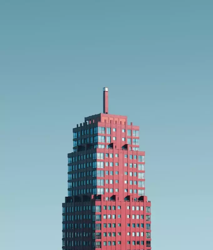 Tall red building with a spire on the roof