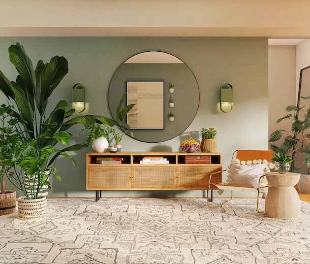 Hallway room with lots of plants and a large round mirror