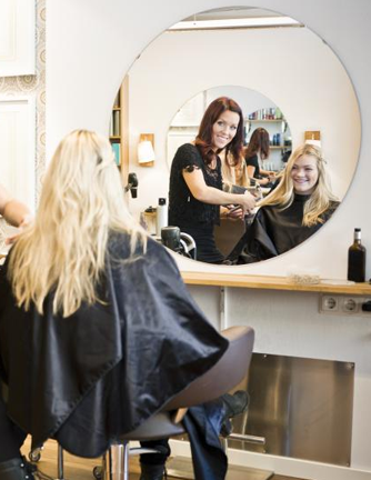 hairdresser with client and mirror