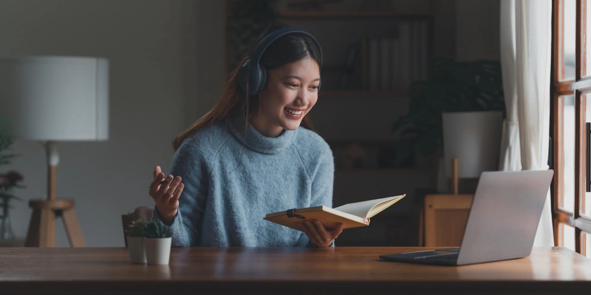 a girl in headphones holding a book