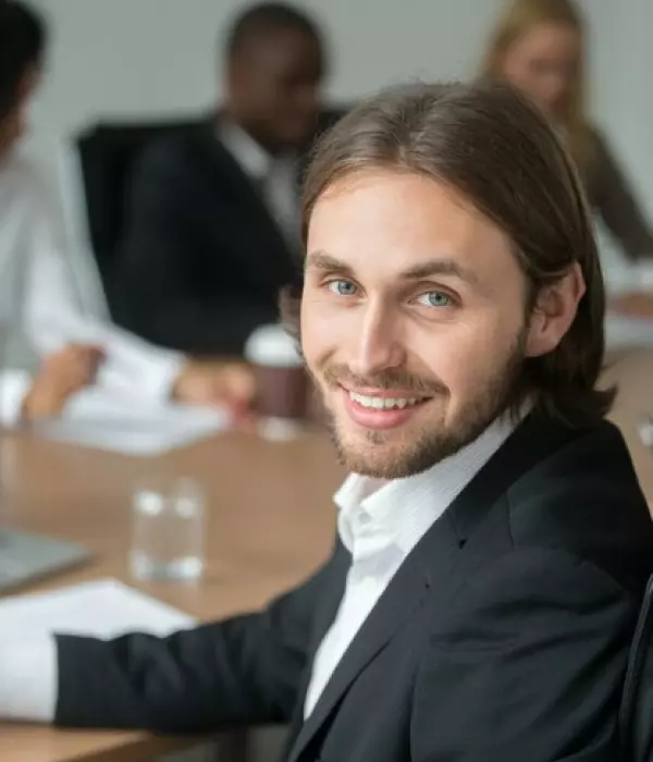 a man with long hair in a suit