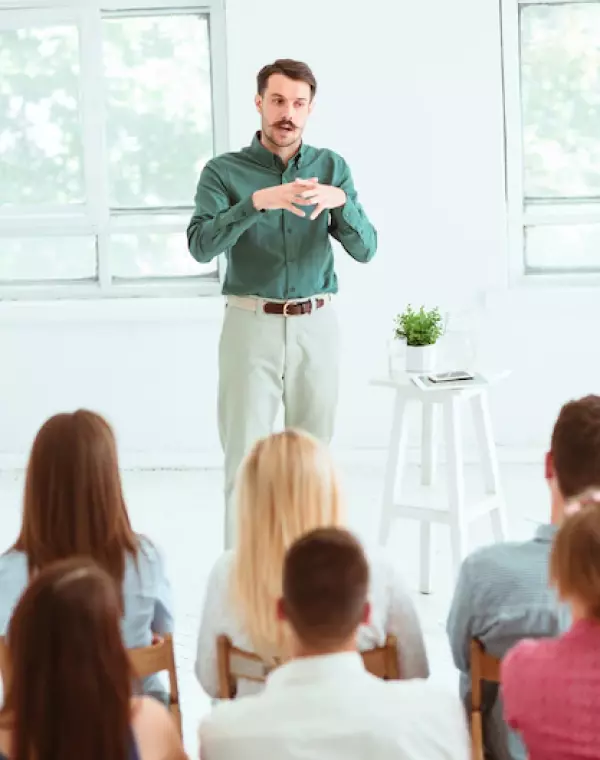 A man in a shirt tells the audience