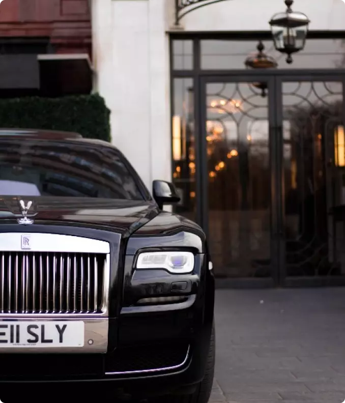 black rolls royce on the background of the hotel