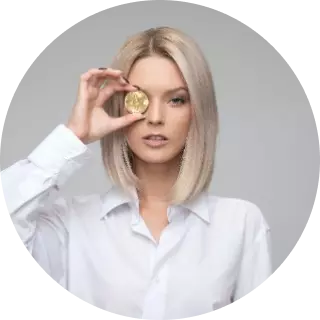 blonde woman in a white shirt holding a coin near her eye