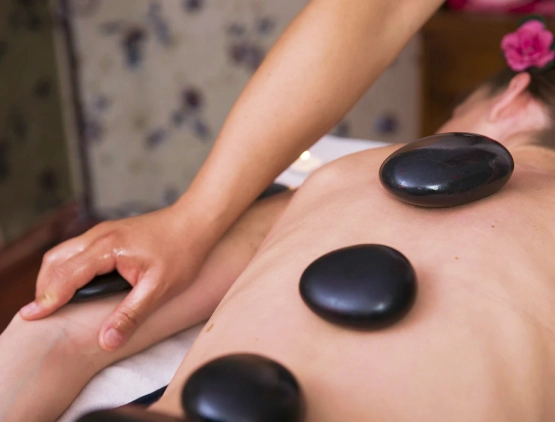 a massage using hot, black rocks to relax muscles and tension