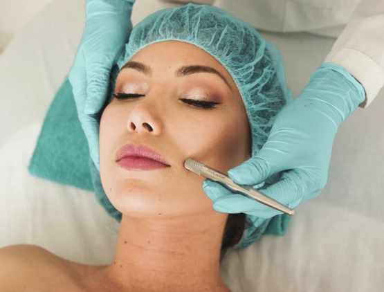 woman wearing a surgical cap having her makeup applied 