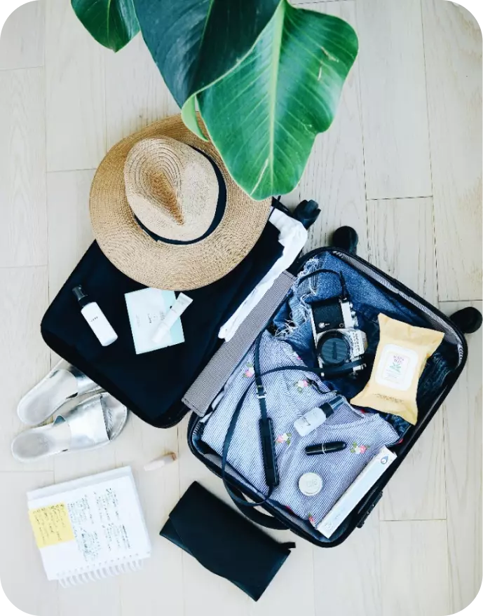 a suitcase filled with things, cosmetics and a camera