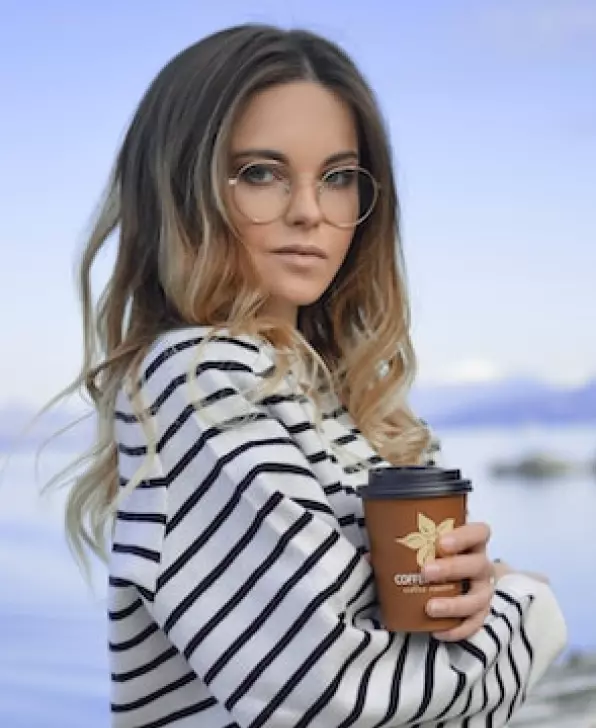 a girl in a striped sweatshirt and glasses