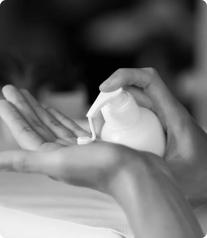 female hands squeezing cream from a container