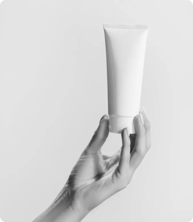 hand holding a tube of cream