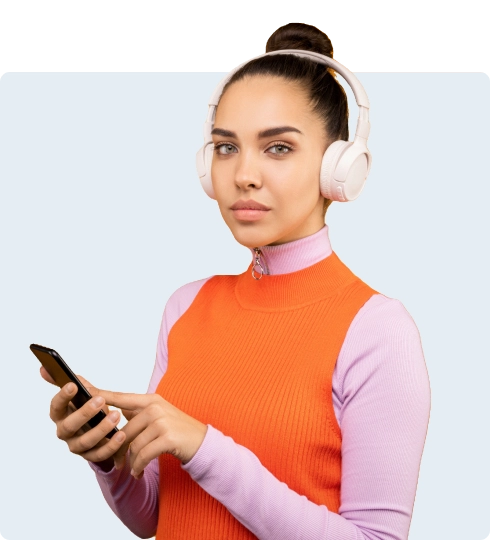 girl with headphones on her head, wearing an orange T-shirt over a sweater