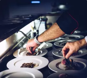 The chef's hands cut the dish