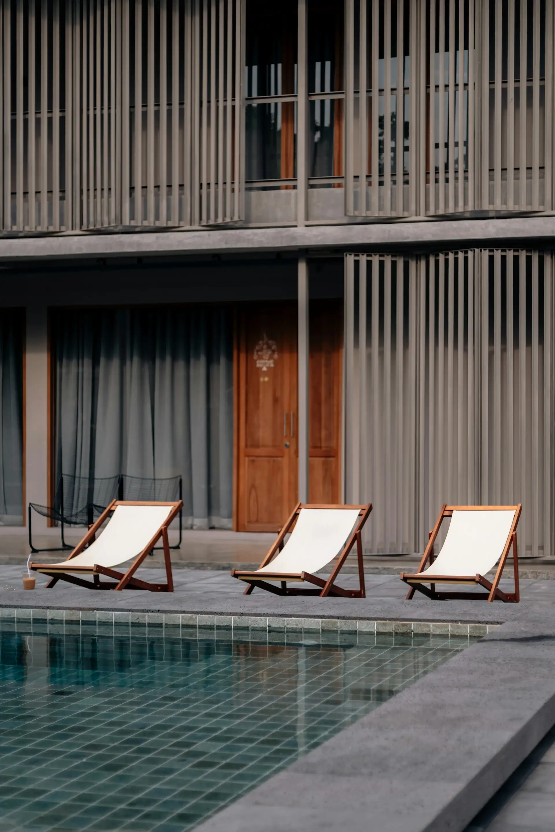 courtyard of a modern house with a swimming pool and sun loungers