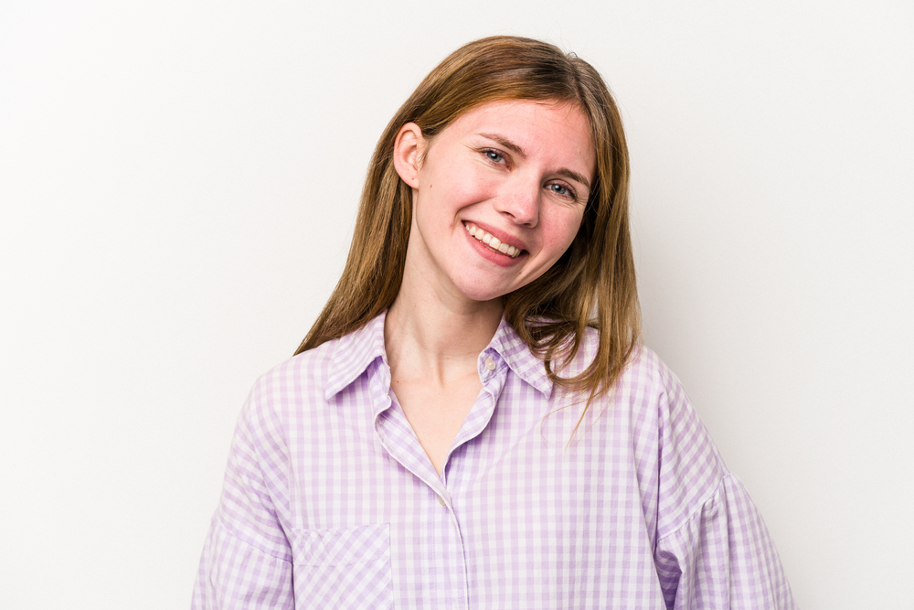 girl with a wide smile in a checkered shirt