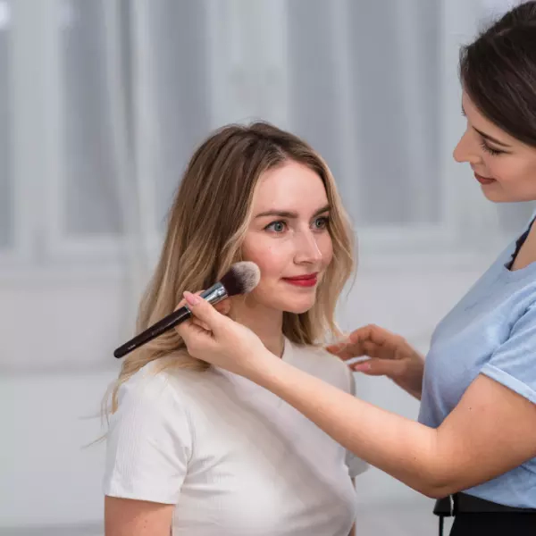 A girl is getting her makeup done