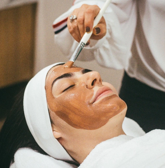 girl undergoing the procedure of applying a mask to her face