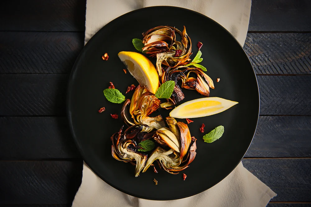 baked vegetables with beautiful presentation on a black plate