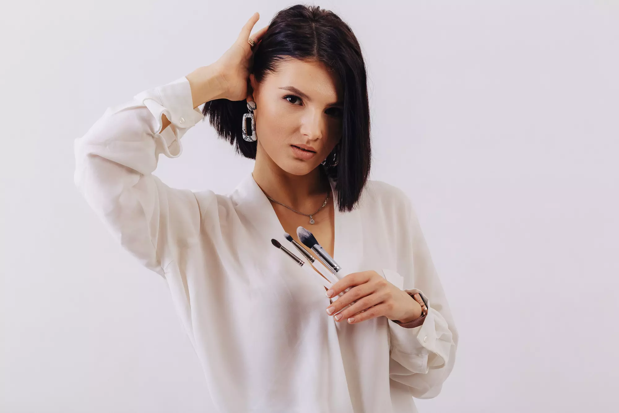 brunette with bob hairstyle in a white shirt