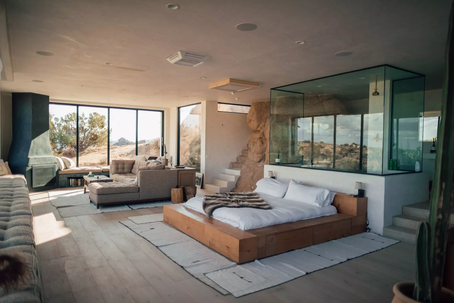 sitting area with two chairs and a table in front of the fireplace