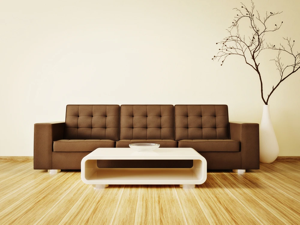 large brown sofa with white table and wood