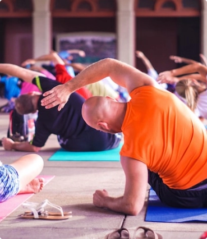 bald older man warms up at a group lesson