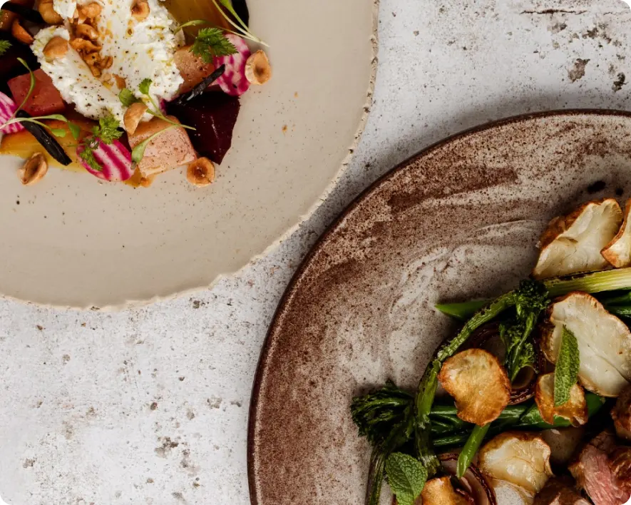 two beautiful plates with vegetable dishes